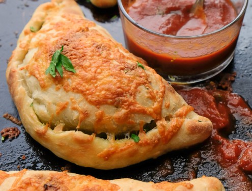 If you're looking for a great vegetarian weeknight meal, check out this Spinach Artichoke Calzone recipe on Shutterbean.com!