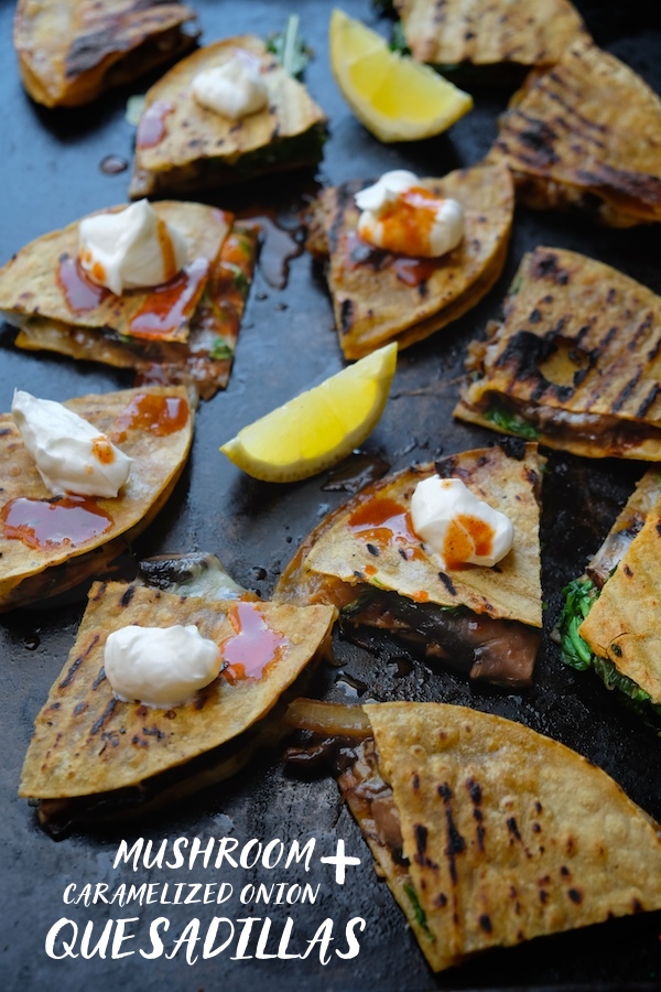 Mushroom & Caramelized Onion Quesadillas with pepperjack cheese & arugula. A perfect, hearty vegetarian dinner. Find the recipe at Shutterbean.com!