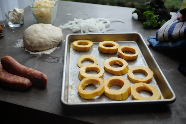 Roasted Delicata Squash Kale Pizza with sausage, caramelized onions and candied walnuts! Recipe on shutterbean.com