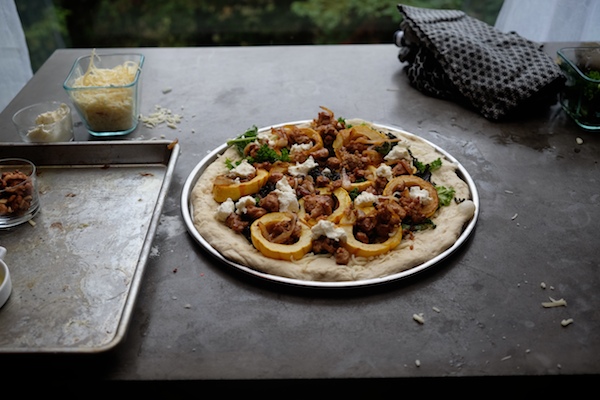 Roasted Delicata Squash Kale Pizza with sausage, caramelized onions and candied walnuts! Recipe on shutterbean.com