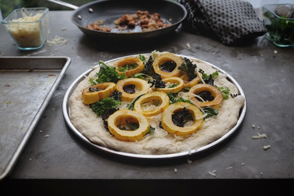 Roasted Delicata Squash Kale Pizza with sausage, caramelized onions and candied walnuts! Recipe on shutterbean.com