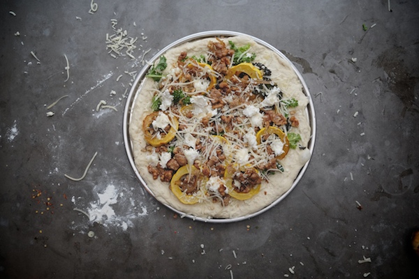 Roasted Delicata Squash Kale Pizza with sausage, caramelized onions and candied walnuts! Recipe on shutterbean.com