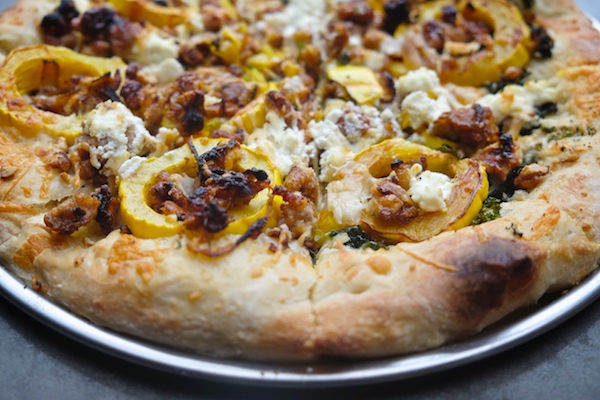 Roasted Delicata Squash Kale Pizza with sausage, caramelized onions and candied walnuts! Recipe on shutterbean.com