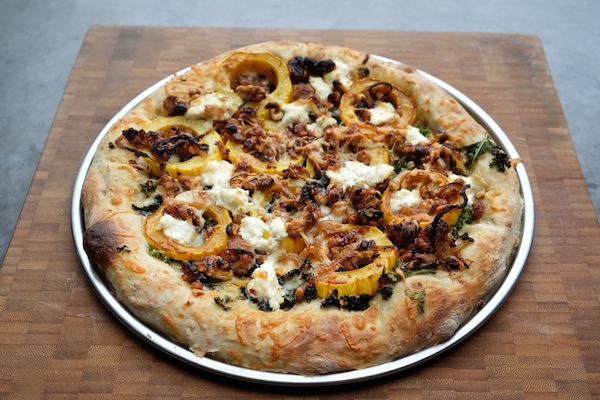 Roasted Delicata Squash Kale Pizza with sausage, caramelized onions and candied walnuts! Recipe on shutterbean.com