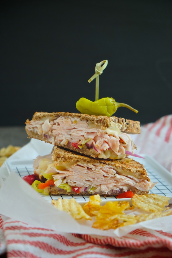 Grilled Turkey Pepper Jack Sandwich made with Dave's Killer Bread. There's roasted peppers & pepperoncini nestled in there! Find the recipe on Shutterbean.com!