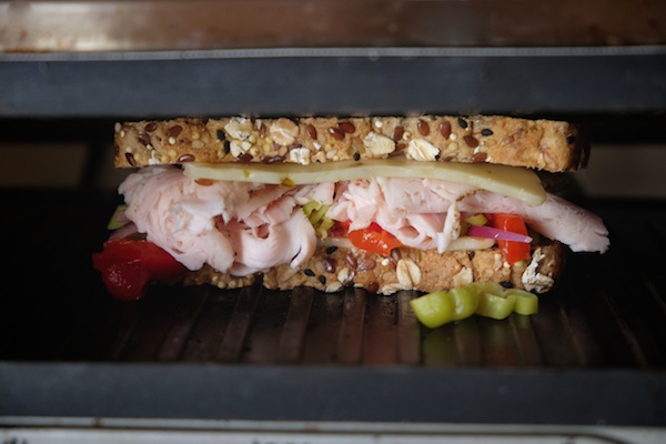 Grilled Turkey Pepper Jack Sandwich made with Dave's Killer Bread. There's roasted peppers & pepperoncini nestled in there! Find the recipe on Shutterbean.com!