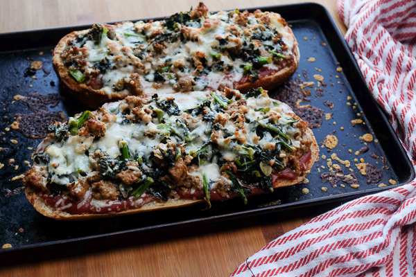 Sausage & Kale French Bread Pizzas are sure to be a crowd pleaser around the dinner table. Find the recipe at Shutterbean.com