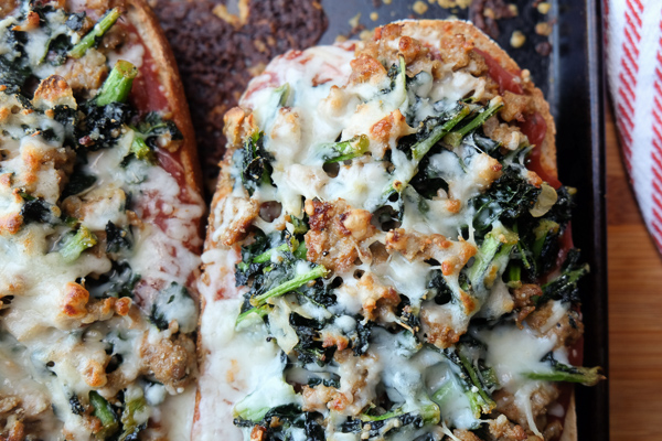 Sausage & Kale French Bread Pizzas are sure to be a crowd pleaser around the dinner table. Find the recipe at Shutterbean.com