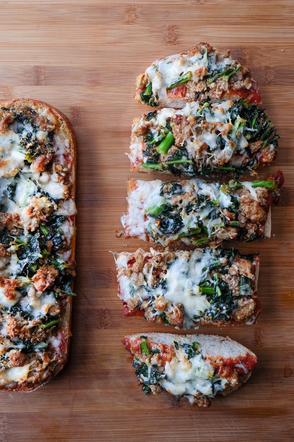 Sausage & Kale French Bread Pizzas are sure to be a crowd pleaser around the dinner table. Find the recipe at Shutterbean.com