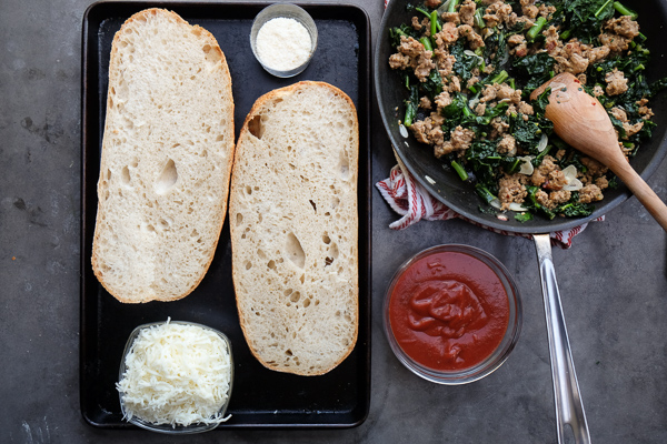 Sausage & Kale French Bread Pizzas are sure to be a crowd pleaser around the dinner table. Find the recipe at Shutterbean.com