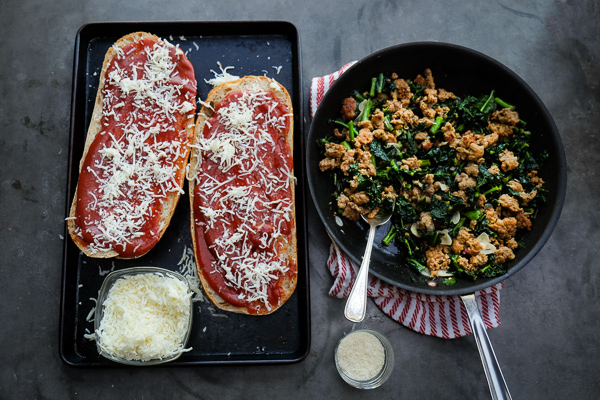 Sausage & Kale French Bread Pizzas are sure to be a crowd pleaser around the dinner table. Find the recipe at Shutterbean.com