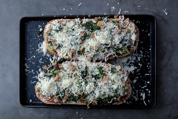 Sausage & Kale French Bread Pizzas are sure to be a crowd pleaser around the dinner table. Find the recipe at Shutterbean.com