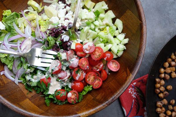 Chopped Salad with Spiced Chickpeas made with a lemon tahini dressing. Find the recipe on Shutterbean.com!