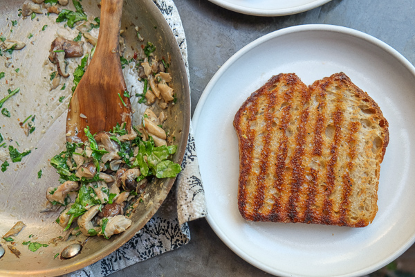 Creamy Mushroom Arugula Toast with Poached Eggs. Find the recipe on Shutterbean.com