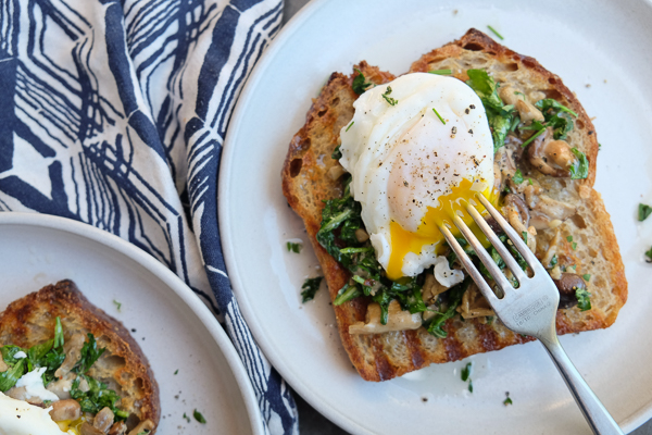 Creamy Mushroom Arugula Toast with Poached Eggs. Find the recipe on Shutterbean.com