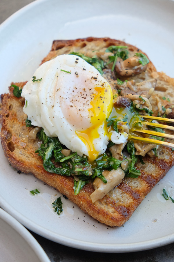 Creamy Mushroom Arugula Toast with Poached Eggs. Find the recipe on Shutterbean.com