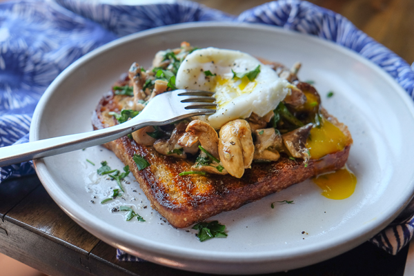 Creamy Mushroom Arugula Toast with Poached Eggs. Find the recipe on Shutterbean.com