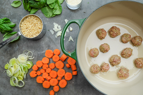 Spring Minestrone with Chicken Meatballs is a perfect soup for those chilly Spring days. Find the recipe on Shutterbean.com!