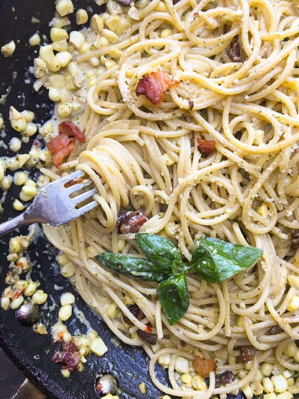 Creamy Corn Basil Pasta studded with crispy bacon. Find the recipe on Shutterbean.com