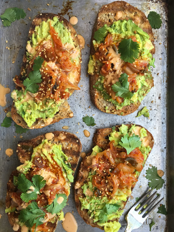 This isn't ordinary avocado toast. It's Avocado Kimchi Toast with a spicy tahini drizzle. Find recipe at Shutterbean.com