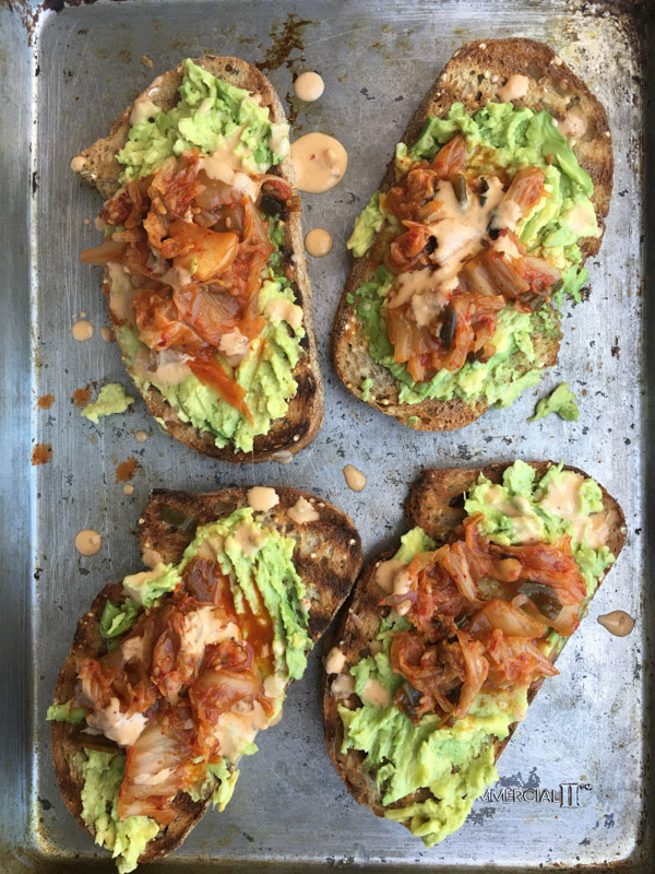 This isn't ordinary avocado toast. It's Avocado Kimchi Toast with a spicy tahini drizzle. Find recipe at Shutterbean.com