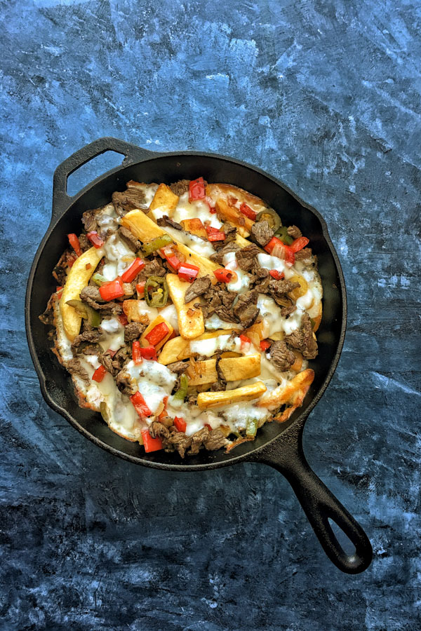 Ditch the bread in Philly Cheesesteak and use FRIES! Find the recipe for these Philly Cheesesteak Fries on Shutterbean.com!