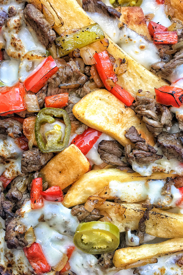 Ditch the bread in Philly Cheesesteak and use FRIES! Find the recipe for these Philly Cheesesteak Fries on Shutterbean.com!