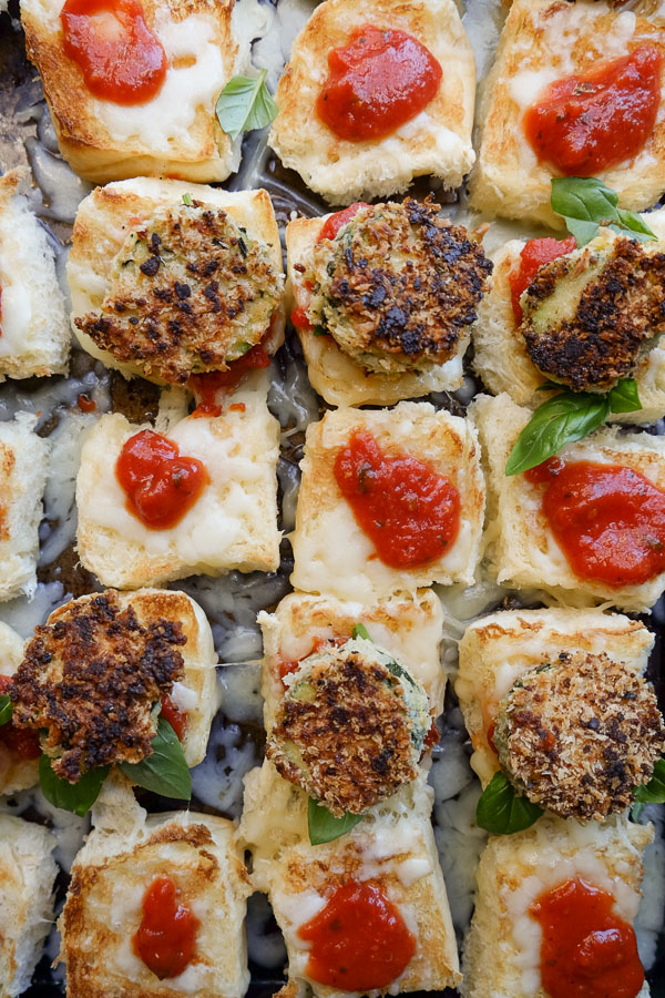 Zucchini Parmesan Sliders are a real crowd pleaser. Vegetarian too! Find the recipe on Shutterbean.com