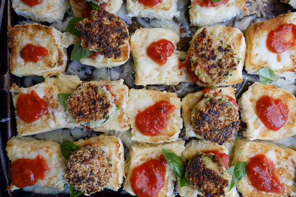 Zucchini Parmesan Sliders are a real crowd pleaser. Vegetarian too! Find the recipe on Shutterbean.com