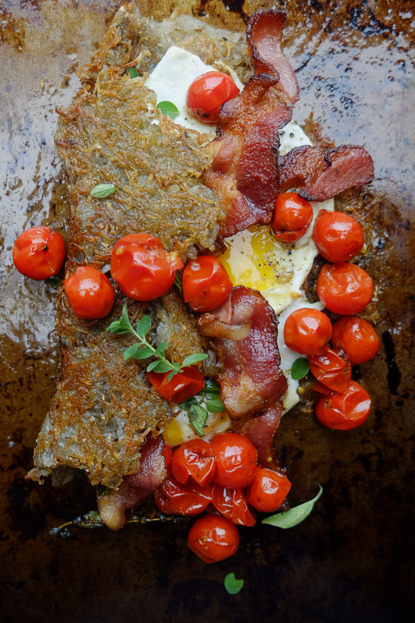 Hash Brown Omelet! A new take on breakfast. Inside you'll find fried eggs, tomatoes with oregano and bacon. Recipe on Shutterbean.com