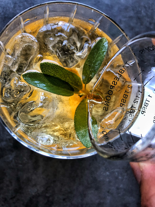 Bourbon Sage Cooler- a refreshing cocktail with just the right amount of sweetness. Find the recipe on Shutterbean.com in partnership with Nugget Markets!