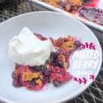 Simple Mixed Berry Crumble with whipped cream is a wonderful summer dessert. Find the recipe on Shutterbean.com!