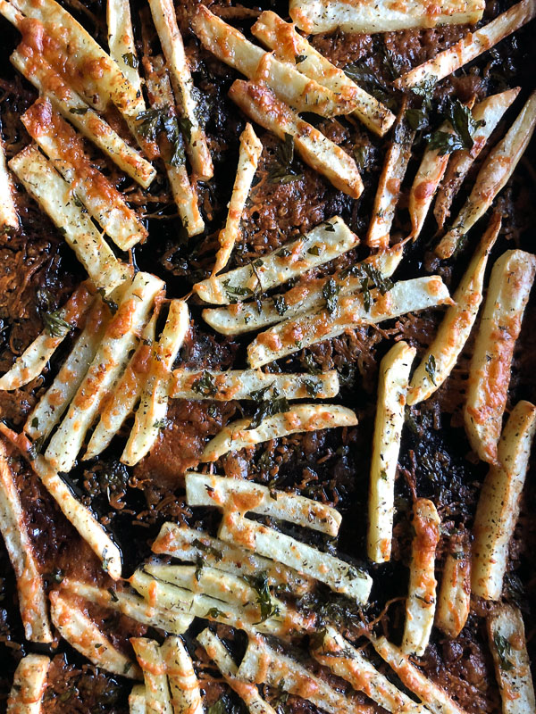 Want to impress dinner guests? Make these crispy Italian Fries! A combination of melted cheese and Italian herbs will level up your baked oven fry game. Recipe on Shutterbean.com!