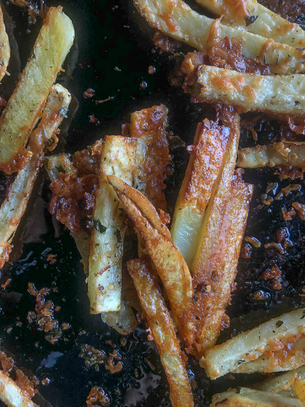 Want to impress dinner guests? Make these crispy Italian Fries! A combination of melted cheese and Italian herbs will level up your baked oven fry game. Recipe on Shutterbean.com!
