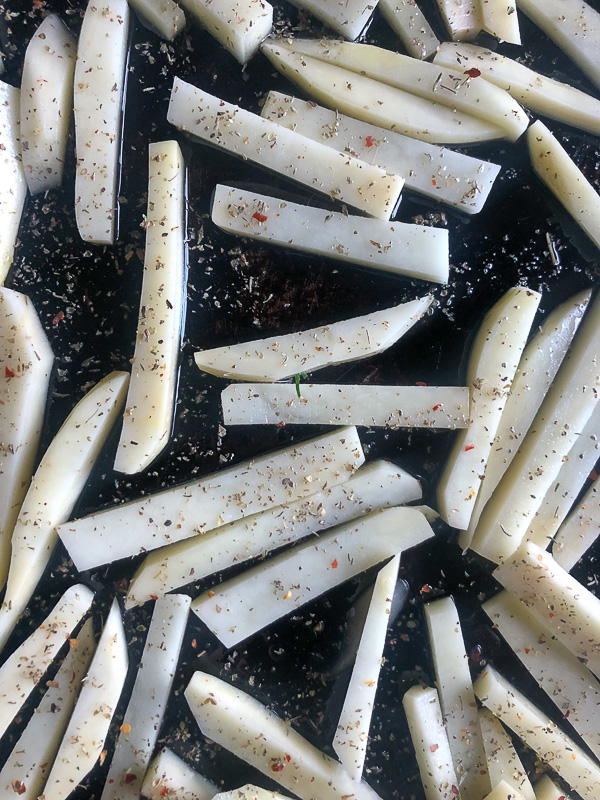 Want to impress dinner guests? Make these crispy Italian Fries! A combination of melted cheese and Italian herbs will level up your baked oven fry game. Recipe on Shutterbean.com!