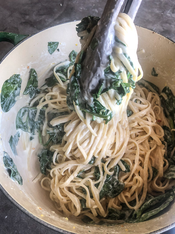 Creamy Goat Cheese and Spinach Pasta is a snap to put together on a weeknight. The sauce is made creamy with goat cheese and pasta water. Recipe on Shutterbean.com!