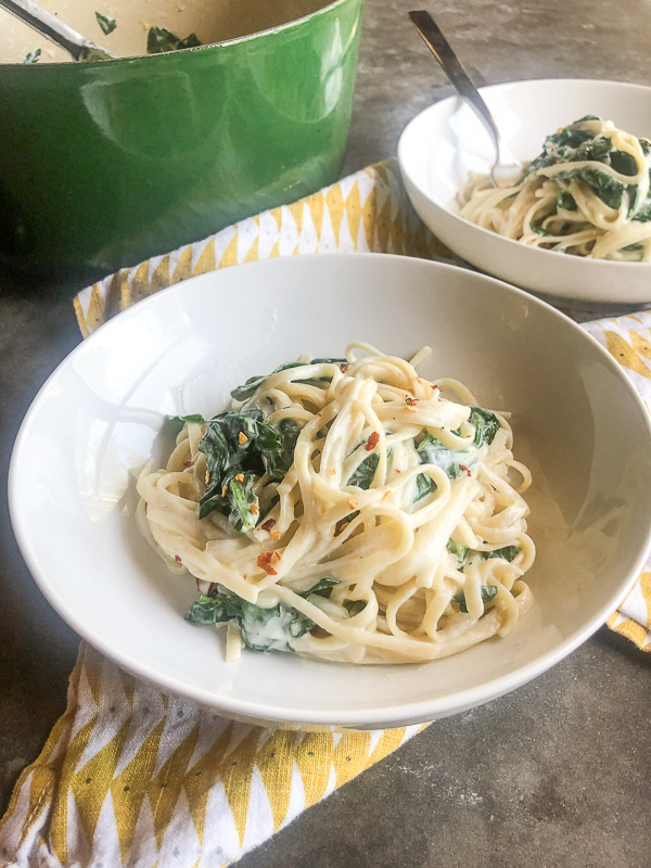 Creamy Goat Cheese and Spinach Pasta is a snap to put together on a weeknight. The sauce is made creamy with goat cheese and pasta water. Recipe on Shutterbean.com!