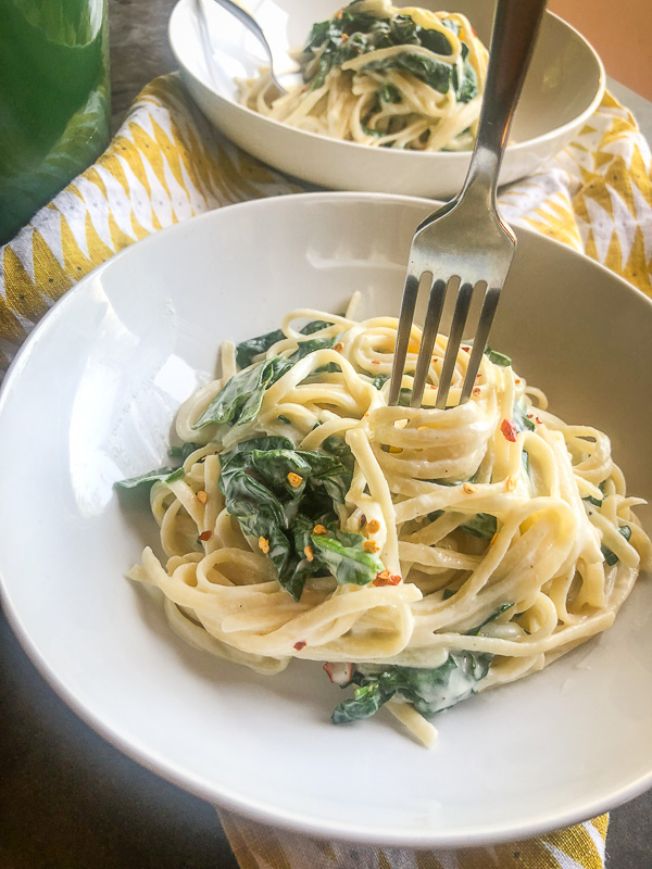 Creamy Goat Cheese and Spinach Pasta is a snap to put together on a weeknight. The sauce is made creamy with goat cheese and pasta water. Recipe on Shutterbean.com!