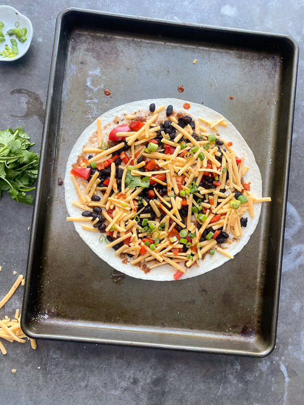 Mexican Pizza is a fun way to shake up dinner. It's like an open-faced quesadilla. Find instructions on Shutterbean.com