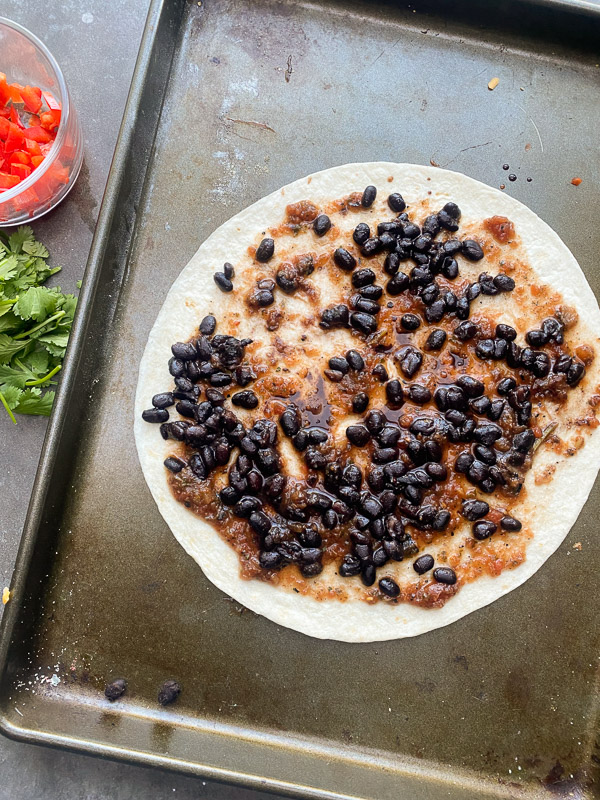 Mexican Pizza is a fun way to shake up dinner. It's like an open-faced quesadilla. Find instructions on Shutterbean.com