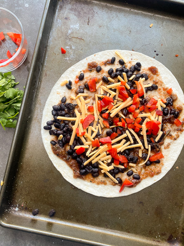 Mexican Pizza is a fun way to shake up dinner. It's like an open-faced quesadilla. Find instructions on Shutterbean.com