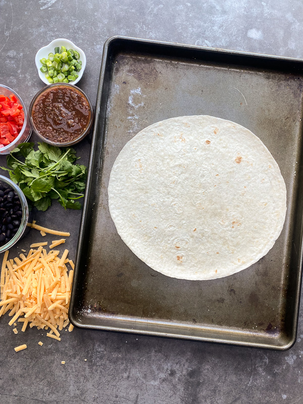 Mexican Pizza is a fun way to shake up dinner. It's like an open-faced quesadilla. Find instructions on Shutterbean.com