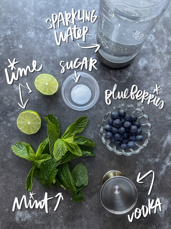 Blueberry Mojito is a refreshing cocktail! Muddled mint and blueberries add color to your life! Find the recipe on Shutterbean.com