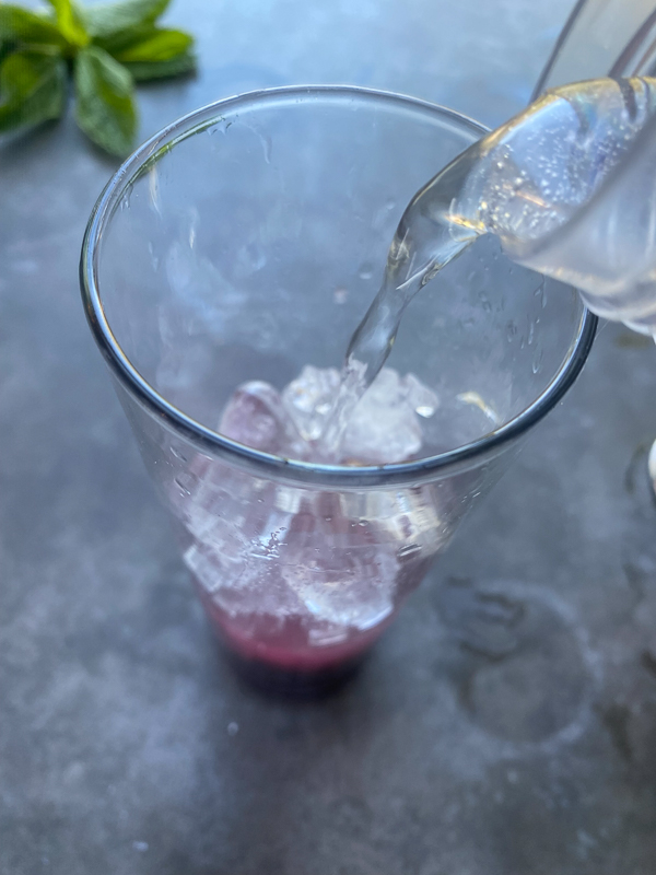 Blueberry Mojito is a refreshing cocktail! Muddled mint and blueberries add color to your life! Find the recipe on Shutterbean.com