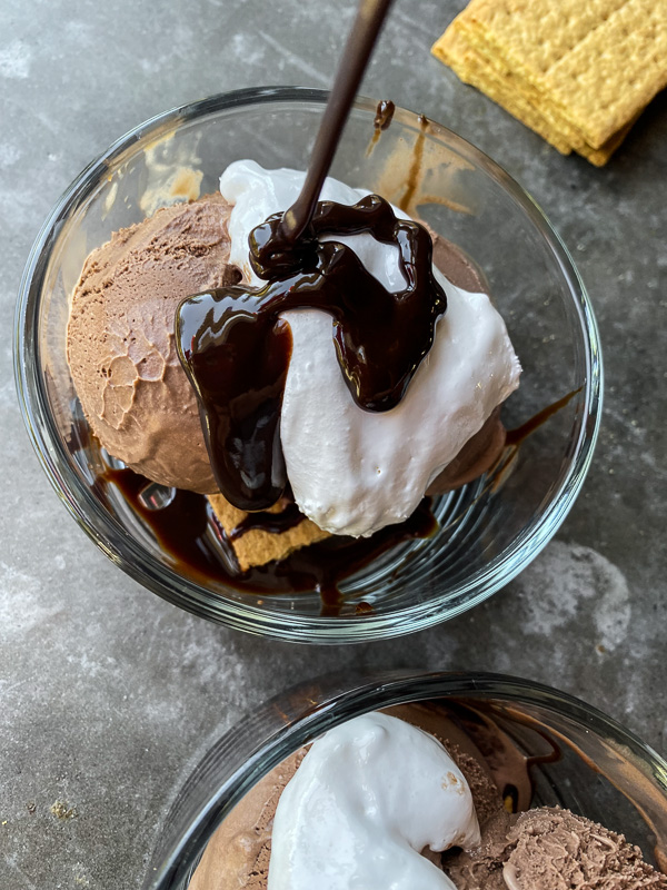 S'mores Sundaes are a combination of chocolate ice cream, marshmallow fluff and hot fudge! Don't forget the graham crackers. Find the recipe on Shutterbean! 