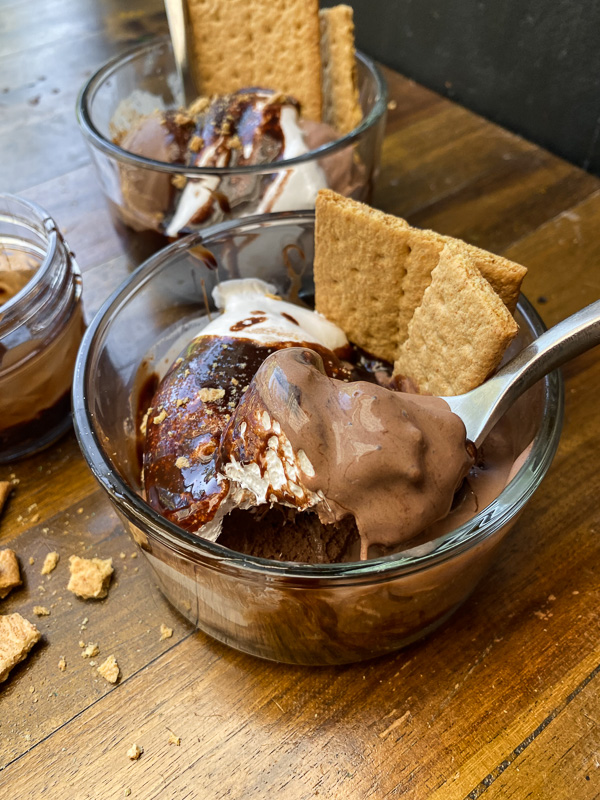 S'mores Sundaes are a combination of chocolate ice cream, marshmallow fluff and hot fudge! Don't forget the graham crackers. Find the recipe on Shutterbean!