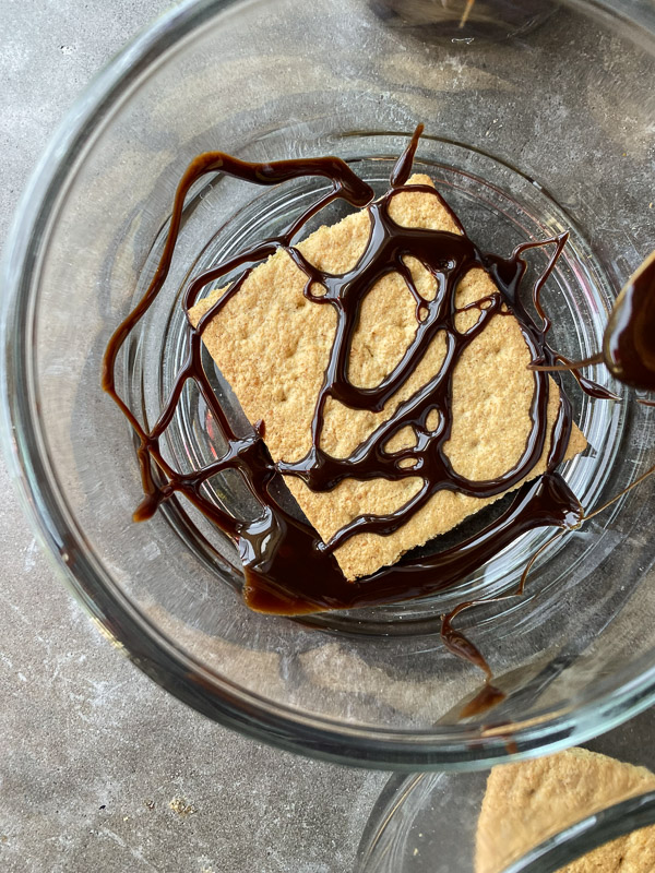 S'mores Sundaes are a combination of chocolate ice cream, marshmallow fluff and hot fudge! Don't forget the graham crackers. Find the recipe on Shutterbean! 