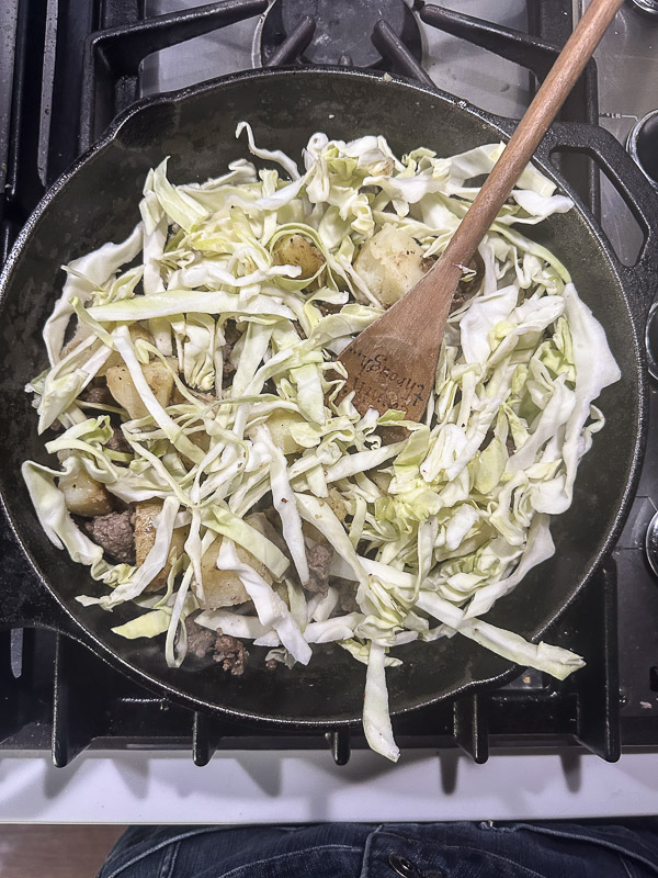 Cabbage Sausage Hash with potatoes, Parmesan topped with a fried egg! Recipe on Shutterbean.com