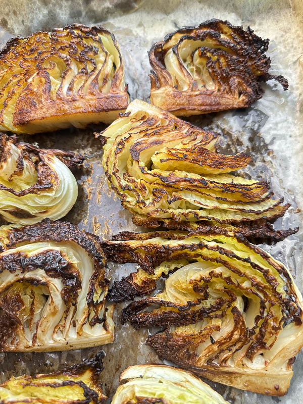 Try this Maple Bacon Cabbage recipe! Roasted cabbage wedges with crispy bacon and a homemade maple Dijon dressing. Easy, flavorful, gluten-free side dish for fall dinners, Thanksgiving, or meal prep. #vegetableside #cabbagerecipes #shutterbean